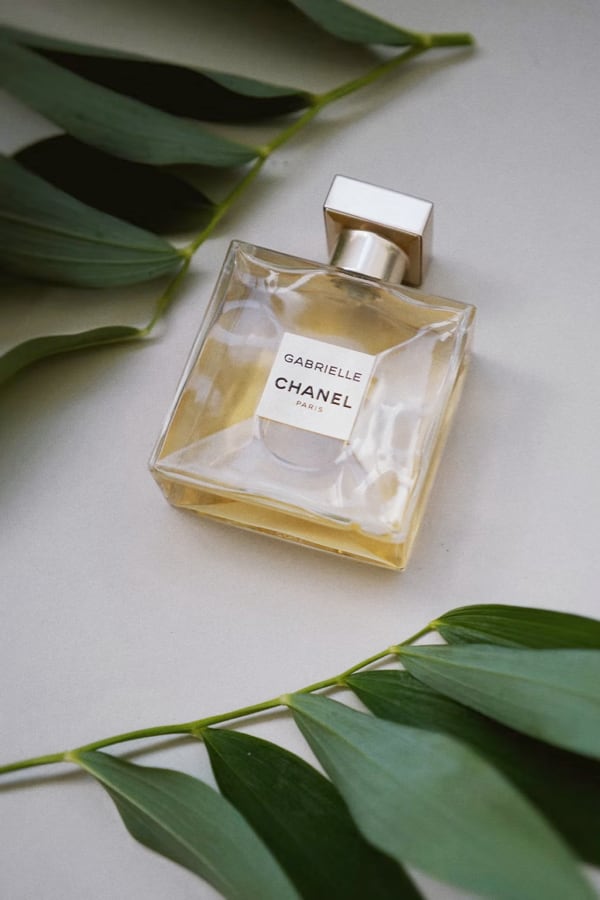 Gabrielle Chanel perfume with elegant leafy background